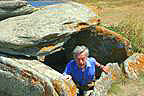 Author emerging  from a 6,000-year-old dolmen burial chamber.